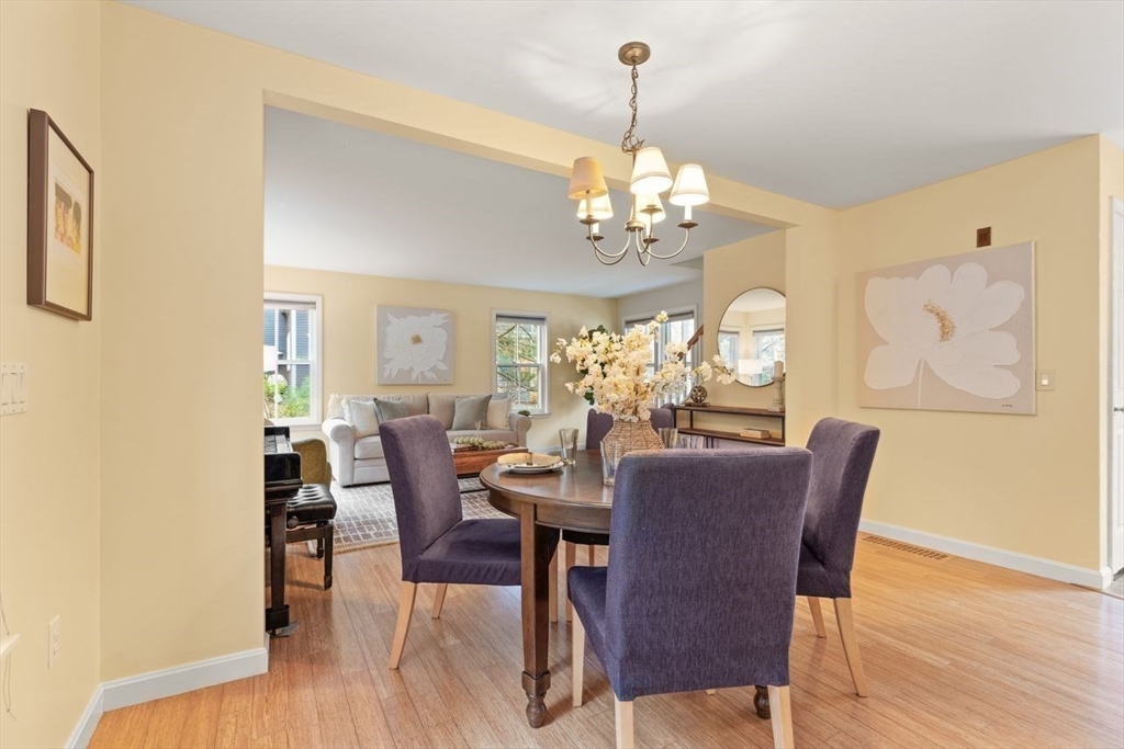 29d S Commons, Unit D Lincoln, MA 01773 - Photo 11 of 36 a view of a dining room with furniture wooden floor and chandelier
