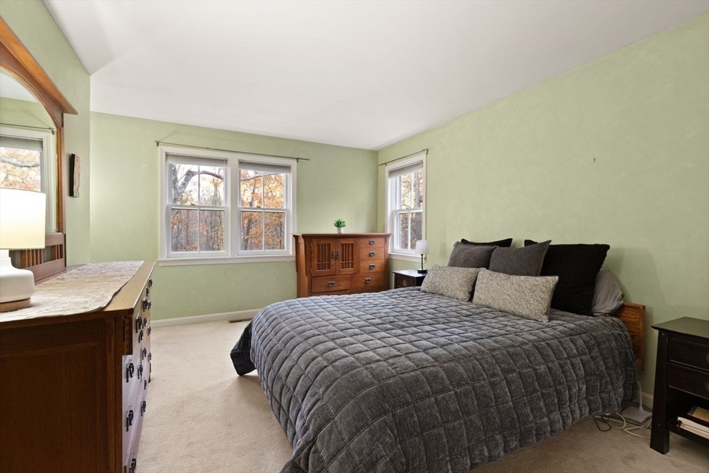 29d S Commons, Unit D Lincoln, MA 01773 - Photo 19 of 36 a bedroom with a bed and a window