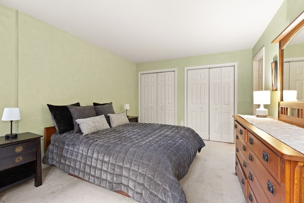29d S Commons, Unit D Lincoln, MA 01773 - Photo 20 of 36 a spacious bedroom with a bed and a window