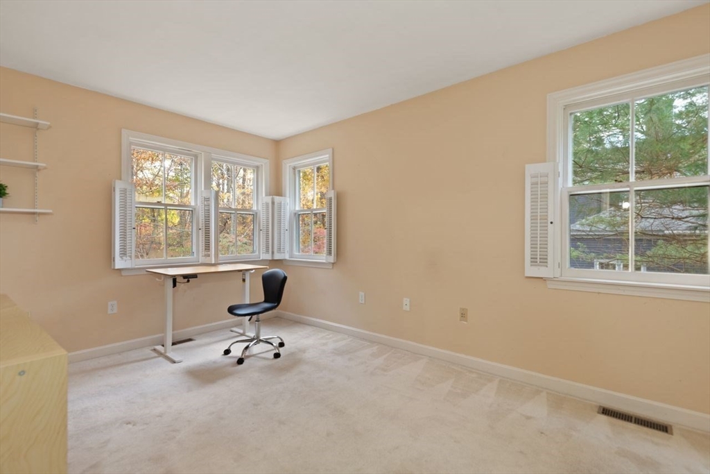 29d S Commons, Unit D Lincoln, MA 01773 - Photo 23 of 36 a view of a room with gym equipment and windows