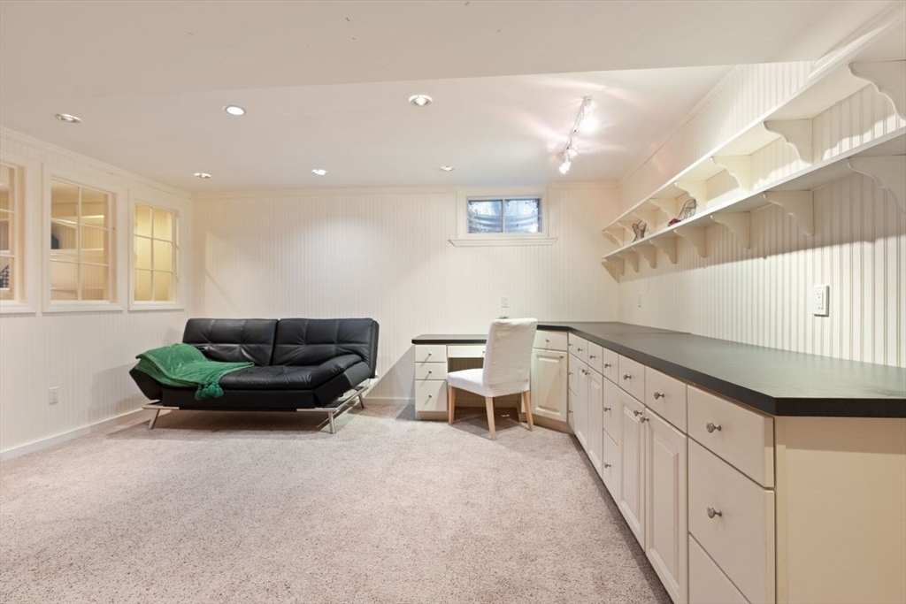 29d S Commons, Unit D Lincoln, MA 01773 - Photo 24 of 36 a living room with furniture and a potted plant