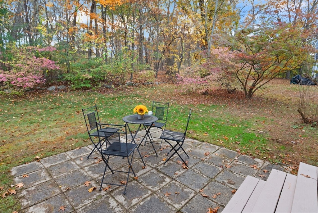 29d S Commons, Unit D Lincoln, MA 01773 - Photo 27 of 36 a view of a chairs and table in backyard