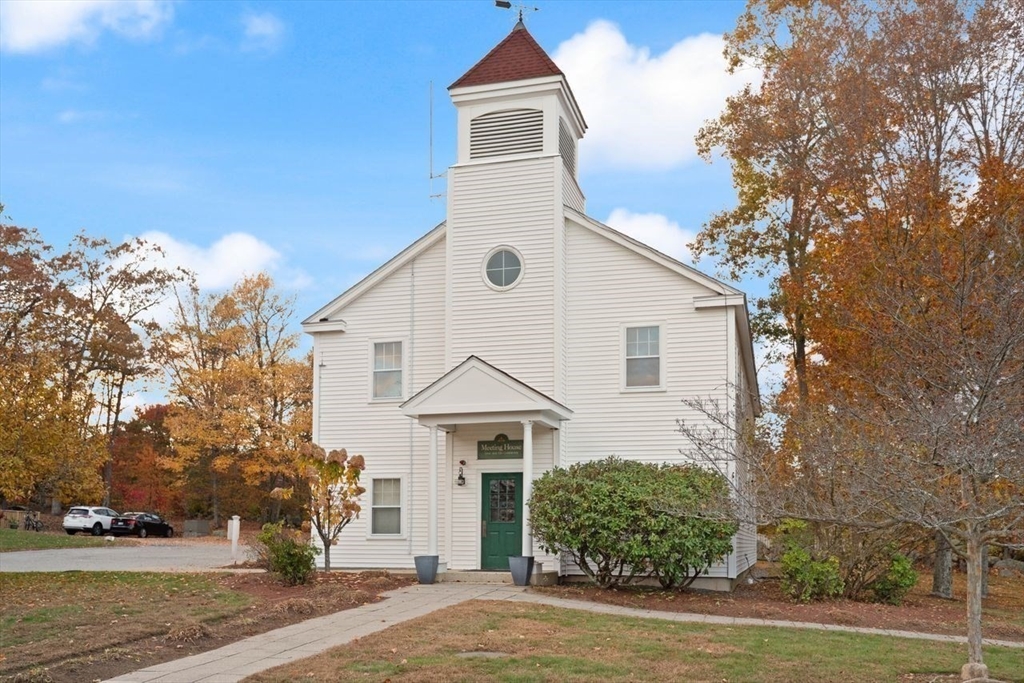 29d S Commons, Unit D Lincoln, MA 01773 - Photo 29 of 36 a view of a white house next to a road and yard