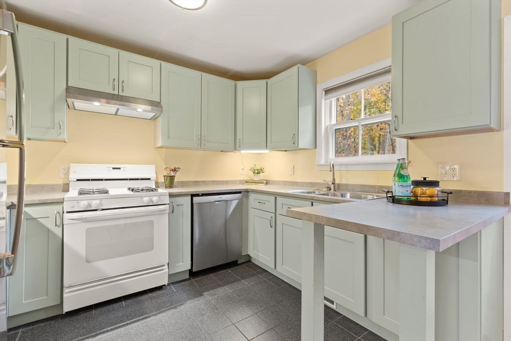 29d S Commons, Unit D Lincoln, MA 01773 - Photo 5 of 36 a kitchen with a sink cabinets and window