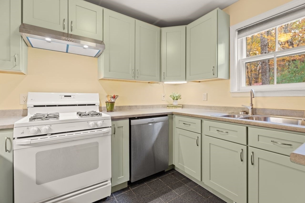 29d S Commons, Unit D Lincoln, MA 01773 - Photo 6 of 36 a kitchen with cabinets appliances a sink and a window