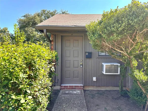 a front view of a house with a plants