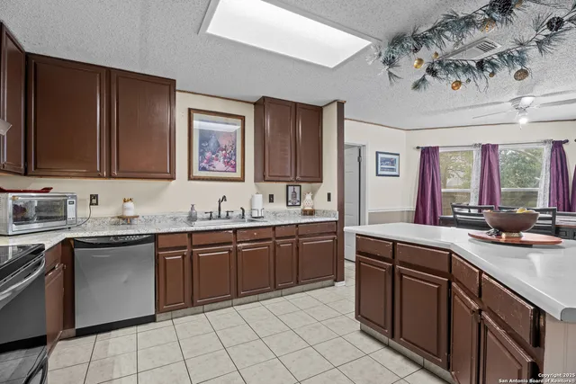 a kitchen with a sink stove and cabinets