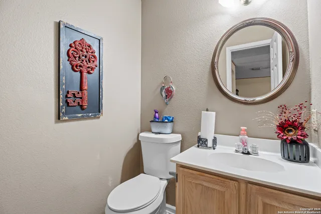 a bathroom with a toilet sink and mirror
