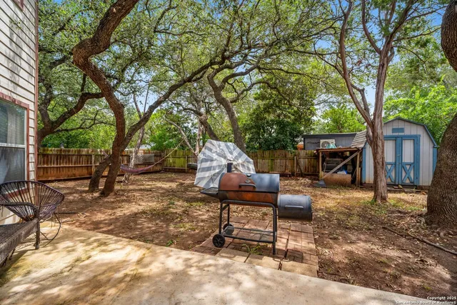 a view of a backyard with a table and chairs