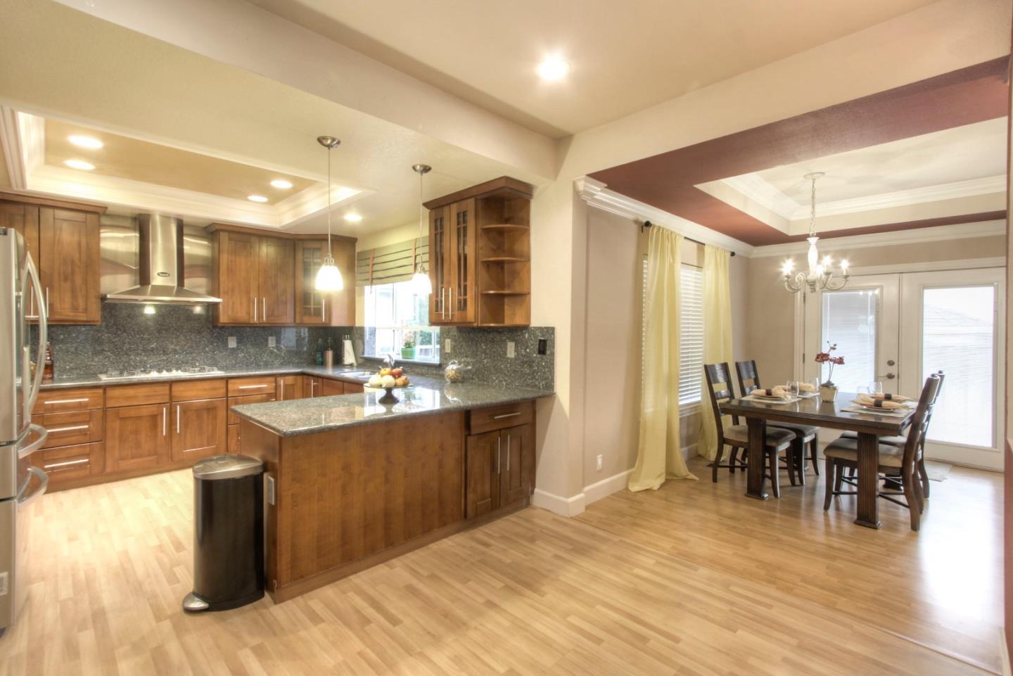 918 Boar Circle Fremont, CA 94539 - Photo 12 of 30 a large kitchen with kitchen island a sink table and chairs