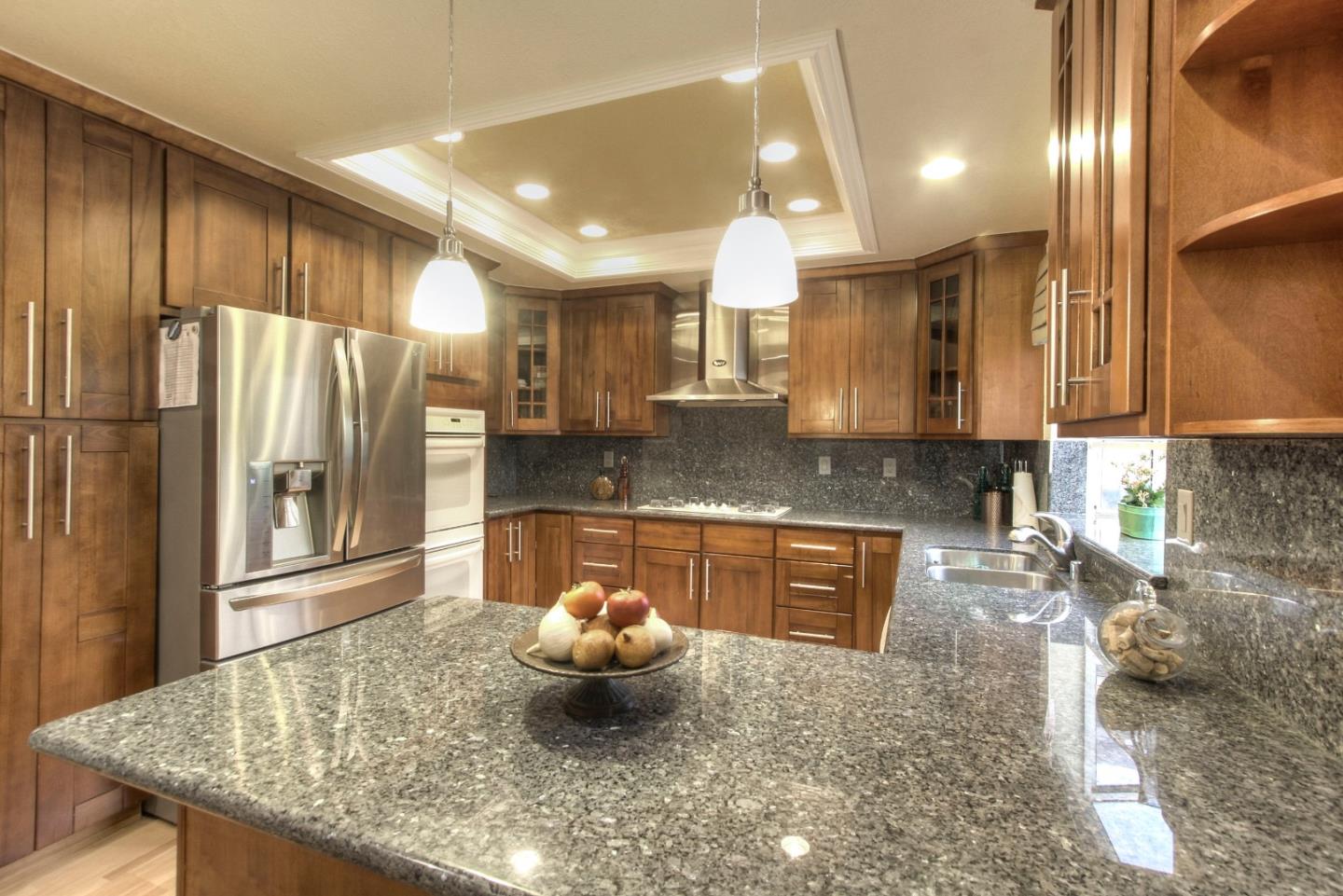 918 Boar Circle Fremont, CA 94539 - Photo 13 of 30 a kitchen with stainless steel appliances granite countertop a sink a stove and a refrigerator