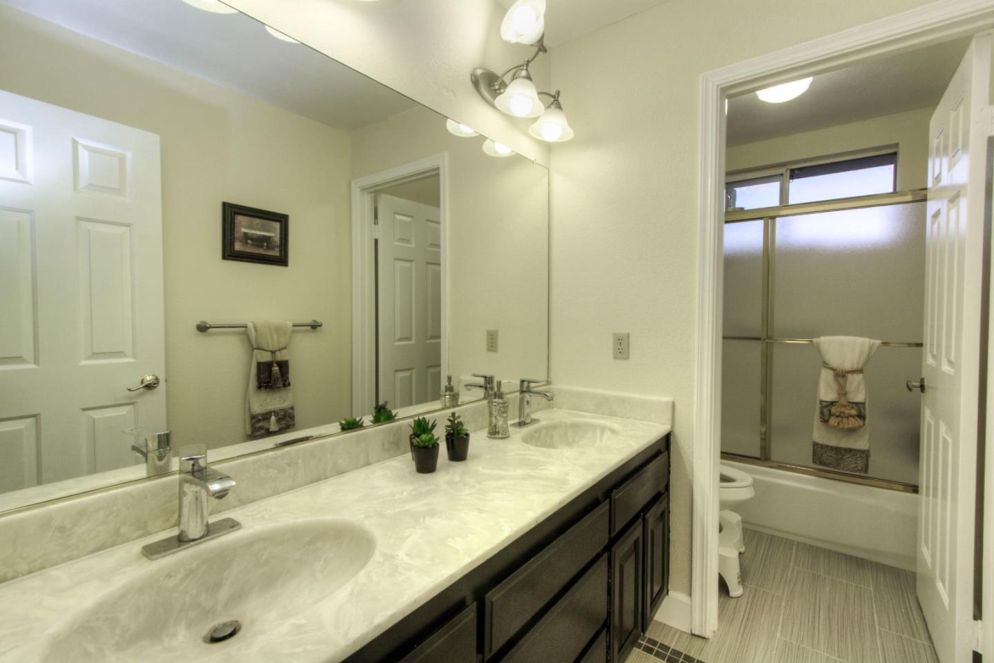 918 Boar Circle Fremont, CA 94539 - Photo 22 of 30 a bathroom with a granite countertop sink a toilet and shower