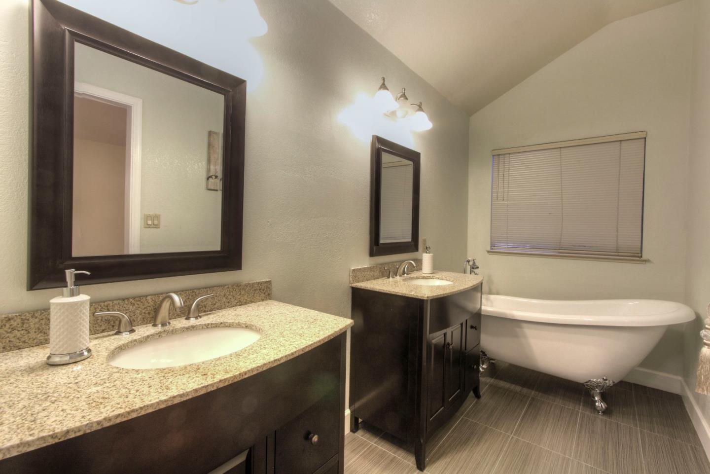 918 Boar Circle Fremont, CA 94539 - Photo 25 of 30 a bathroom with a granite countertop sink mirror and bathtub