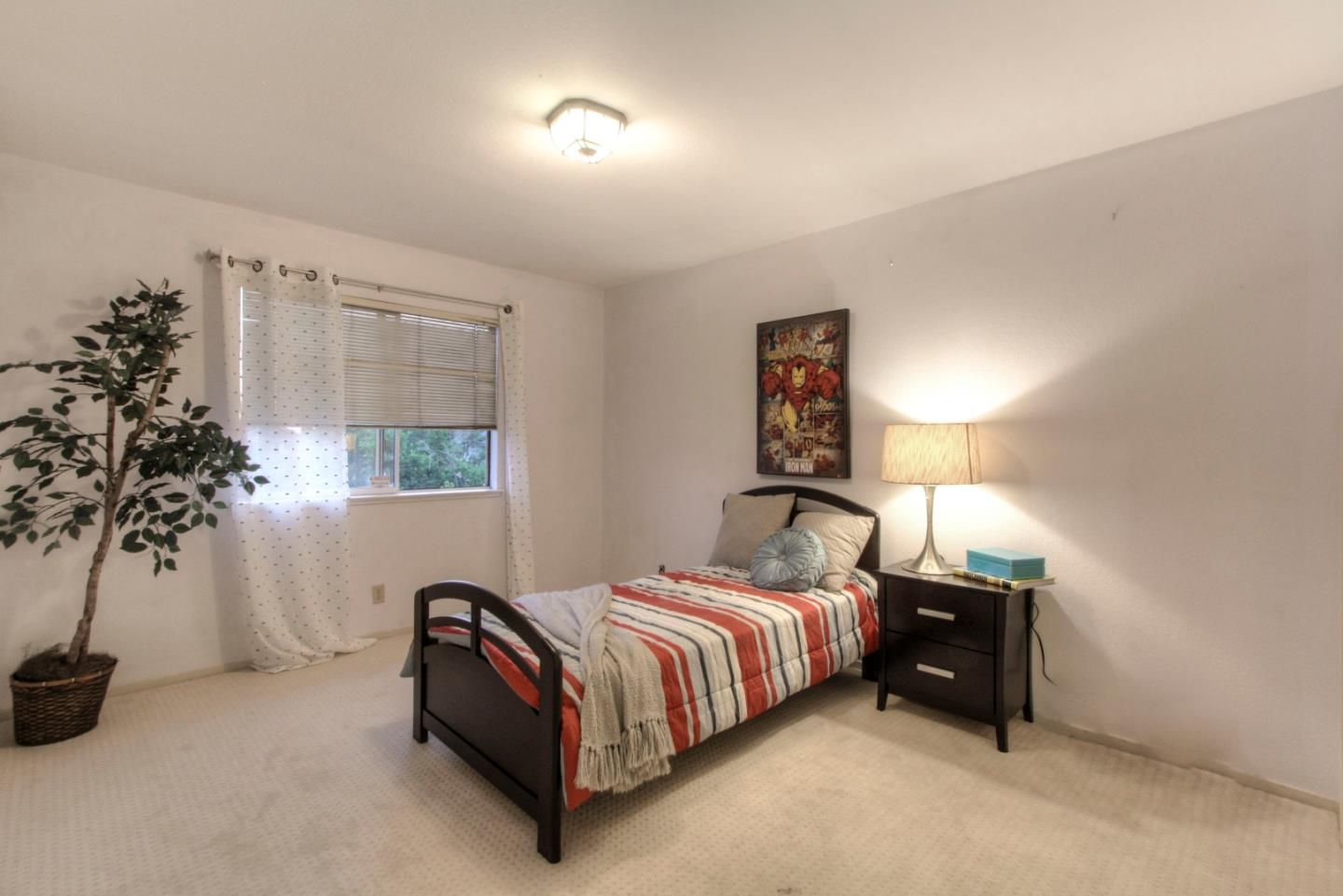 918 Boar Circle Fremont, CA 94539 - Photo 27 of 30 a bedroom with a bed and a potted plant