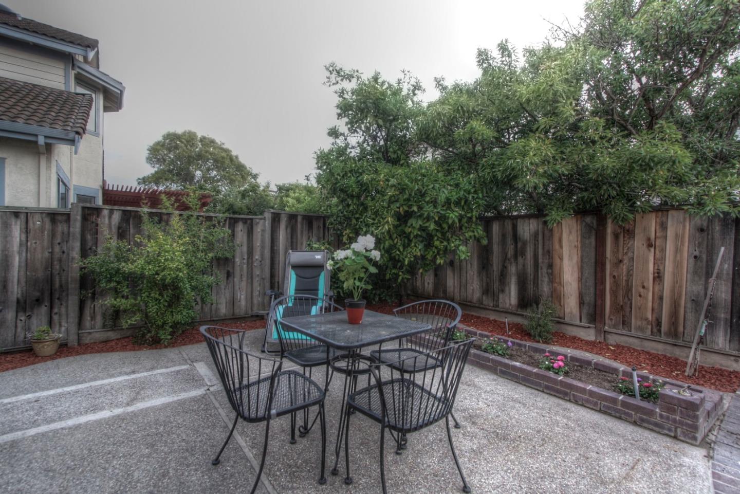 918 Boar Circle Fremont, CA 94539 - Photo 30 of 30 a view of backyard with table and chairs and a large tree