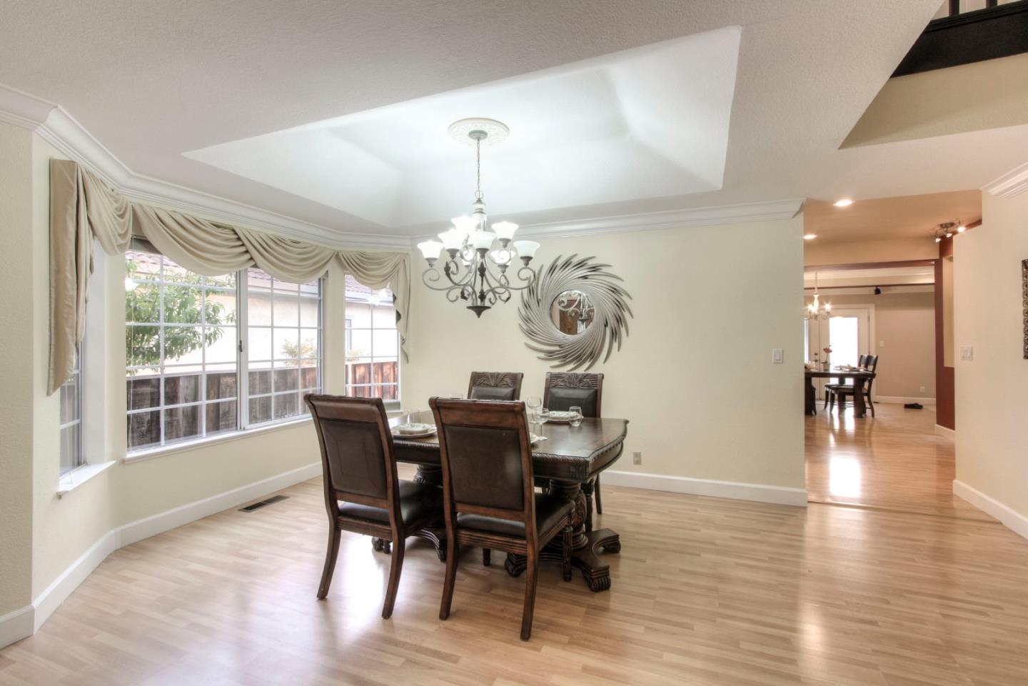 918 Boar Circle Fremont, CA 94539 - Photo 4 of 30 a view of a dining room with furniture a chandelier and wooden floor