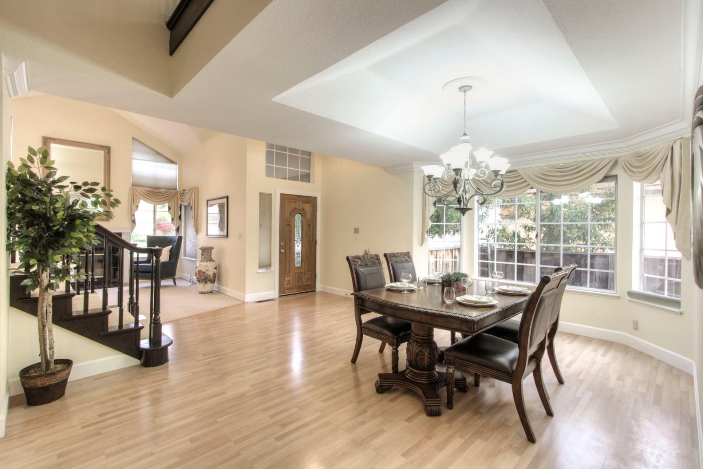918 Boar Circle Fremont, CA 94539 - Photo 5 of 30 a dining room with furniture a chandelier and wooden floor