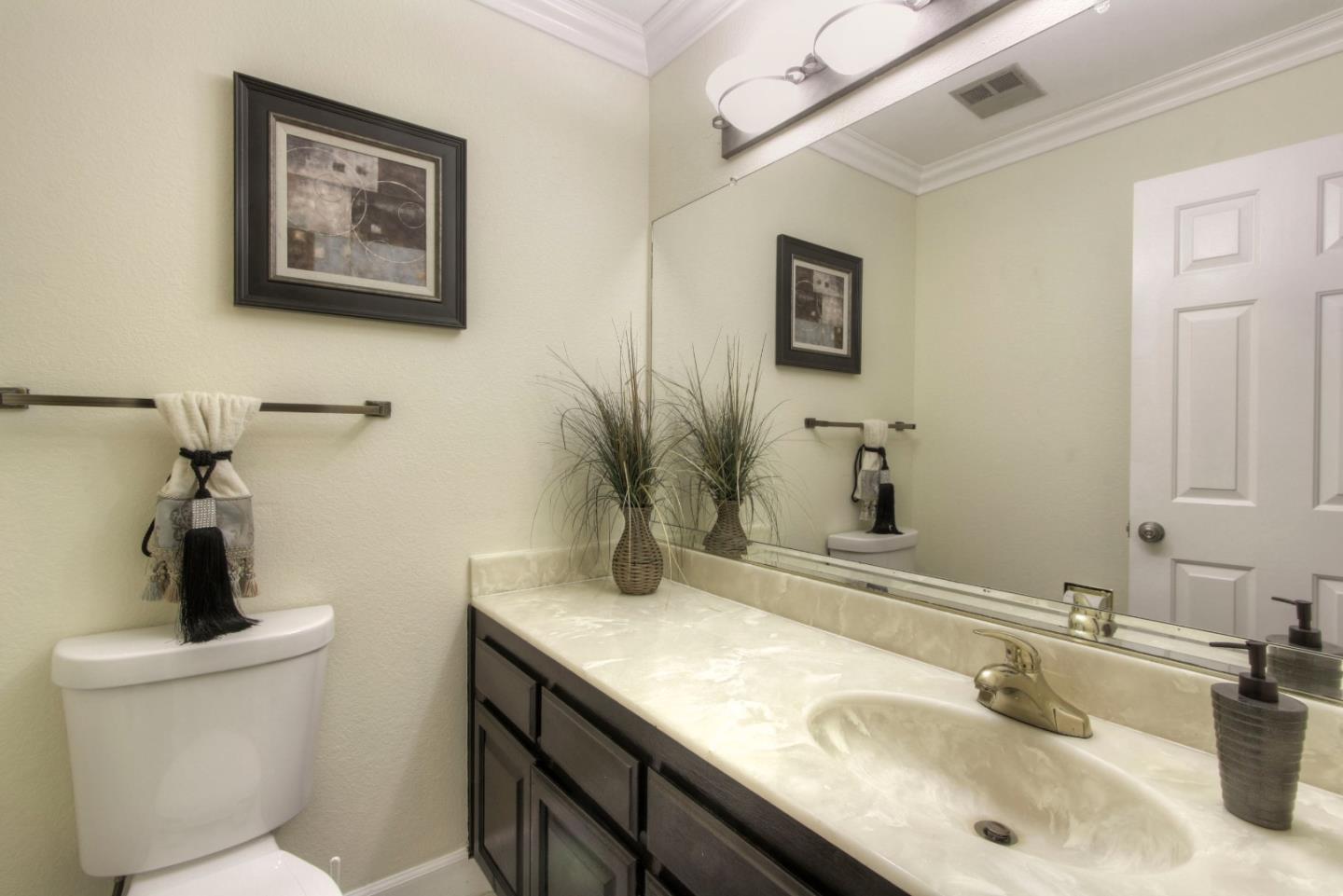 918 Boar Circle Fremont, CA 94539 - Photo 8 of 30 a bathroom with a granite countertop sink a mirror and a toilet