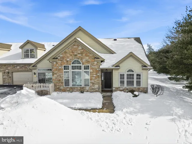 a view of a white house covered in snow