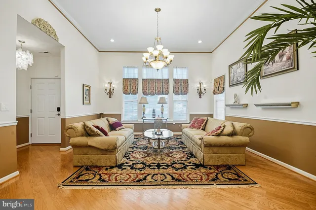 a living room with furniture and a chandelier