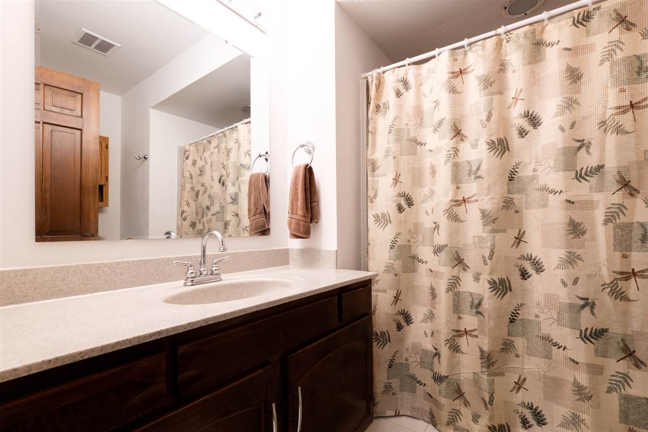 8211 Clockview Road Rockford, IL 61108 - Photo 15 of 25 a bathroom with a sink and a mirror
