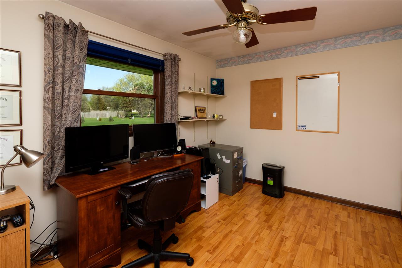 8211 Clockview Road Rockford, IL 61108 - Photo 16 of 25 a bedroom with a workspace