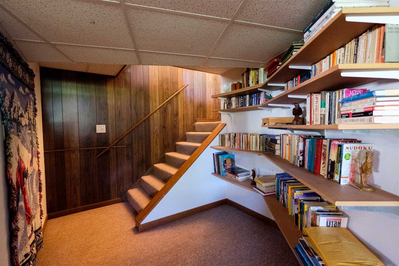 8211 Clockview Road Rockford, IL 61108 - Photo 17 of 25 a living room with lots of books and a book shelf