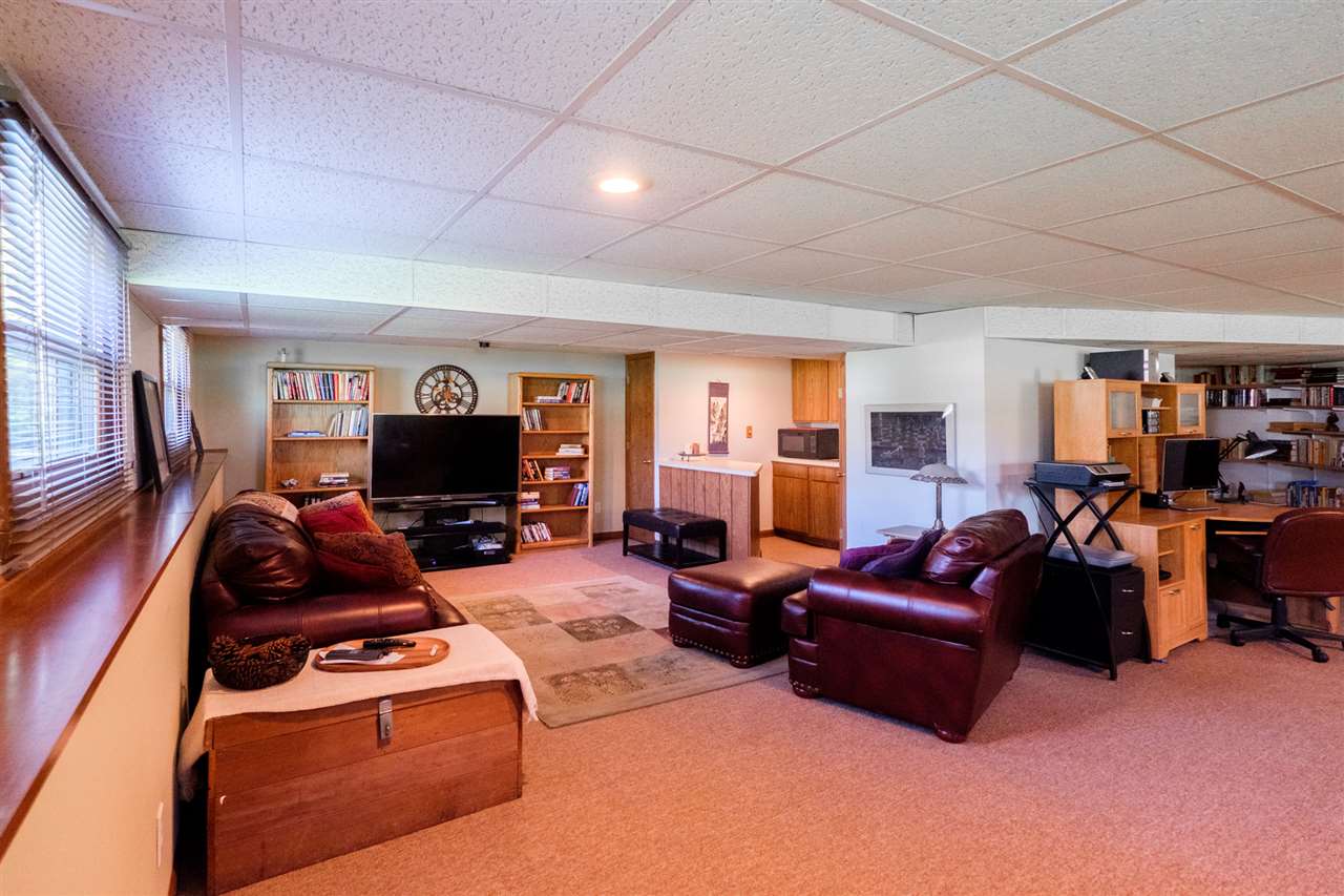 8211 Clockview Road Rockford, IL 61108 - Photo 20 of 25 a living room with furniture a flat screen tv and a fireplace