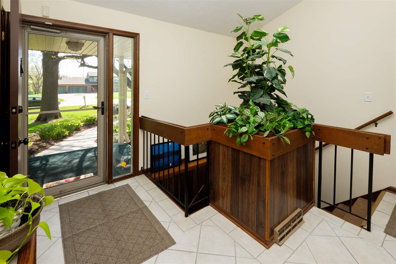 8211 Clockview Road Rockford, IL 61108 - Photo 2 of 25 a porch with a potted plant in front of it