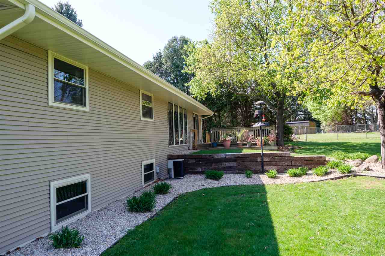 8211 Clockview Road Rockford, IL 61108 - Photo 22 of 25 a front view of a house with garden