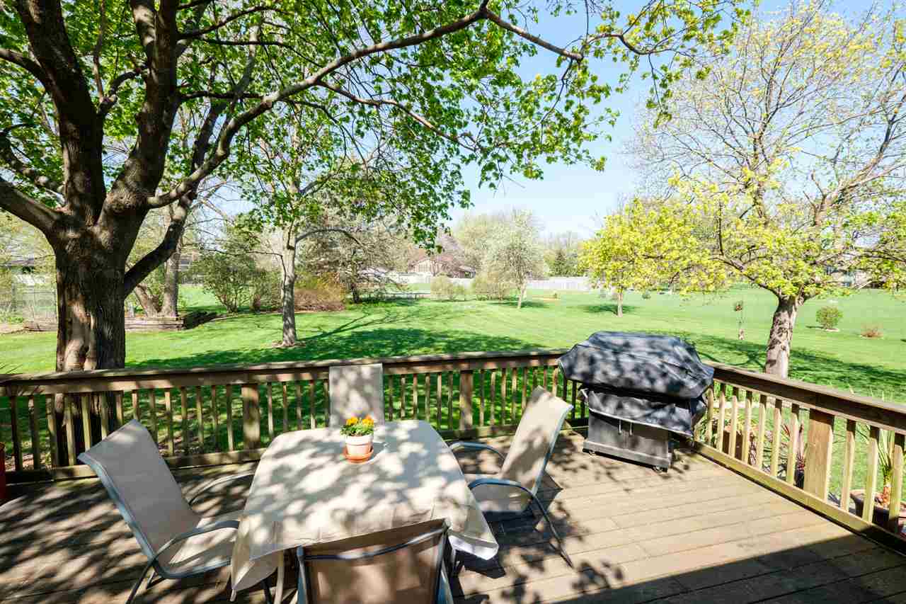8211 Clockview Road Rockford, IL 61108 - Photo 23 of 25 a view of a deck with chair and wooden floor