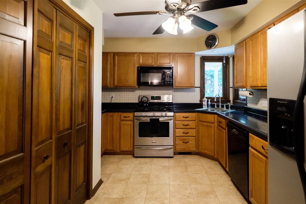 8211 Clockview Road Rockford, IL 61108 - Photo 3 of 25 a kitchen with a stove and a microwave