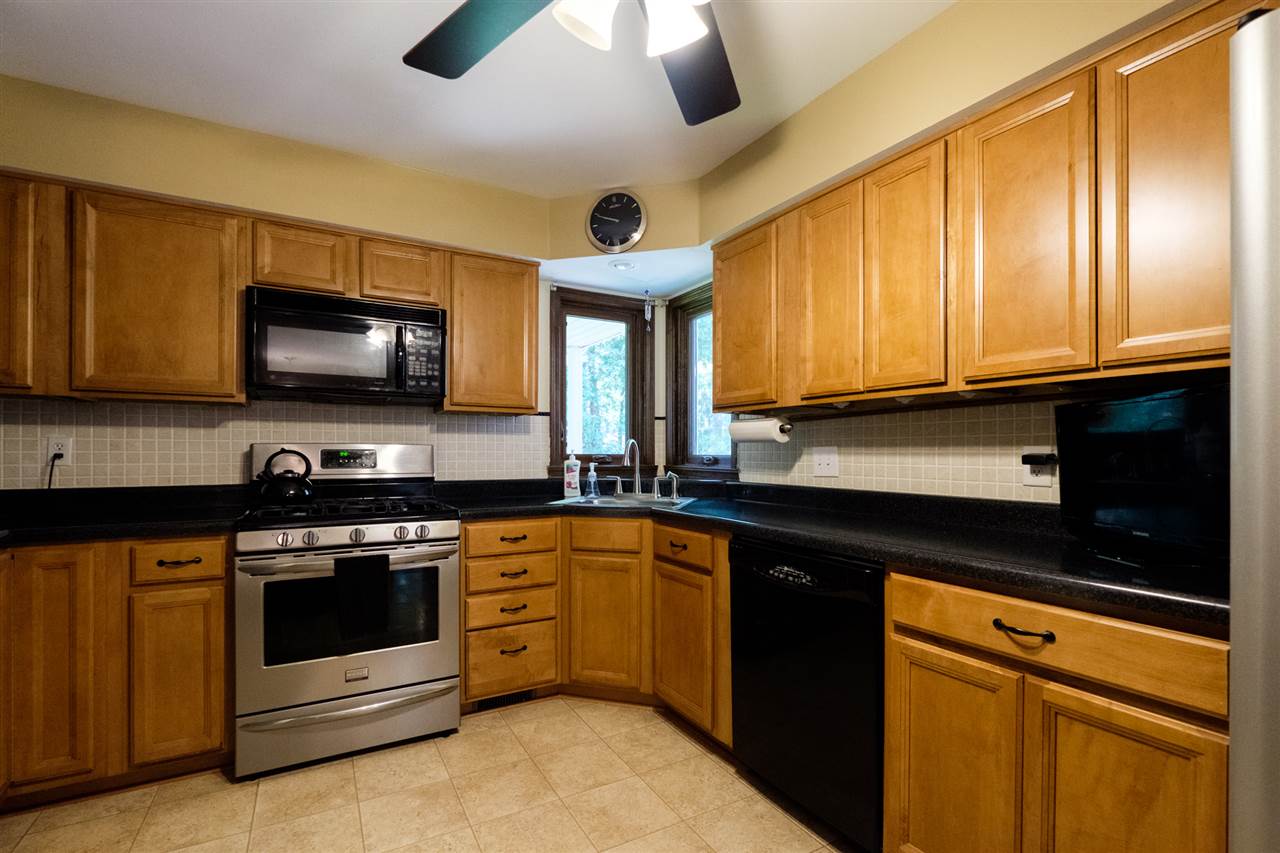 8211 Clockview Road Rockford, IL 61108 - Photo 4 of 25 a kitchen with stainless steel appliances granite countertop a stove and a microwave