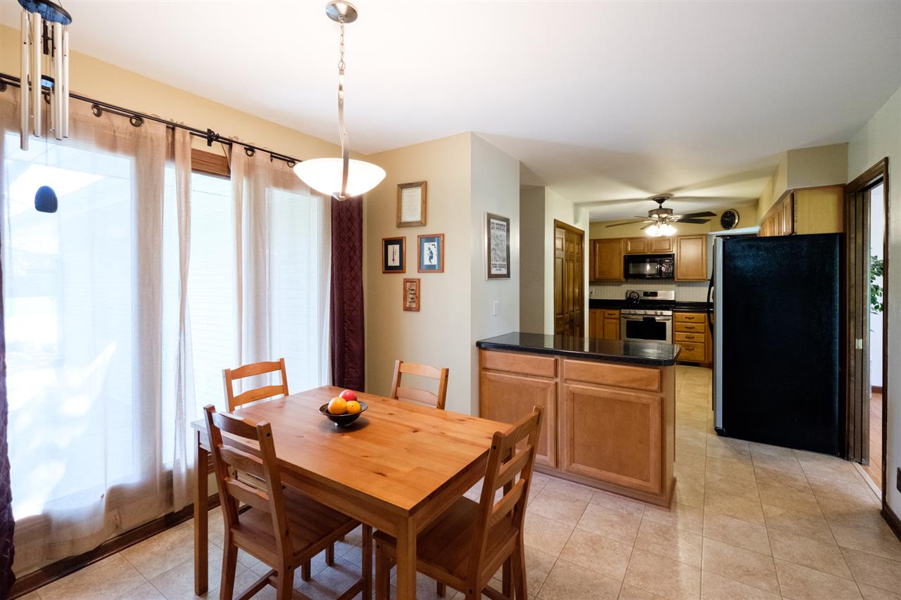 8211 Clockview Road Rockford, IL 61108 - Photo 7 of 25 a kitchen with stainless steel appliances kitchen island granite countertop cabinets and refrigerator