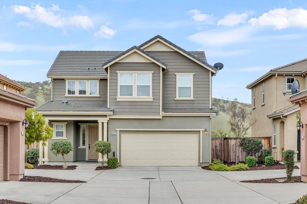 a front view of a house with garage and yard