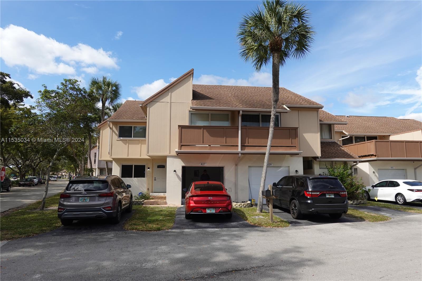 Townhouses at Jacaranda Condominiums Plantation, FL 33324 - Photo 1 of 50 a car parked in front of a house