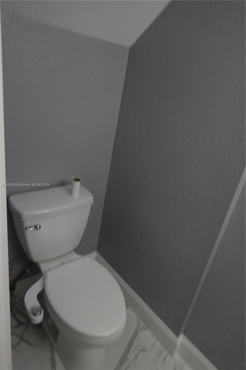 Townhouses at Jacaranda Condominiums Plantation, FL 33324 - Photo 13 of 50 a white toilet sitting next to a white wall