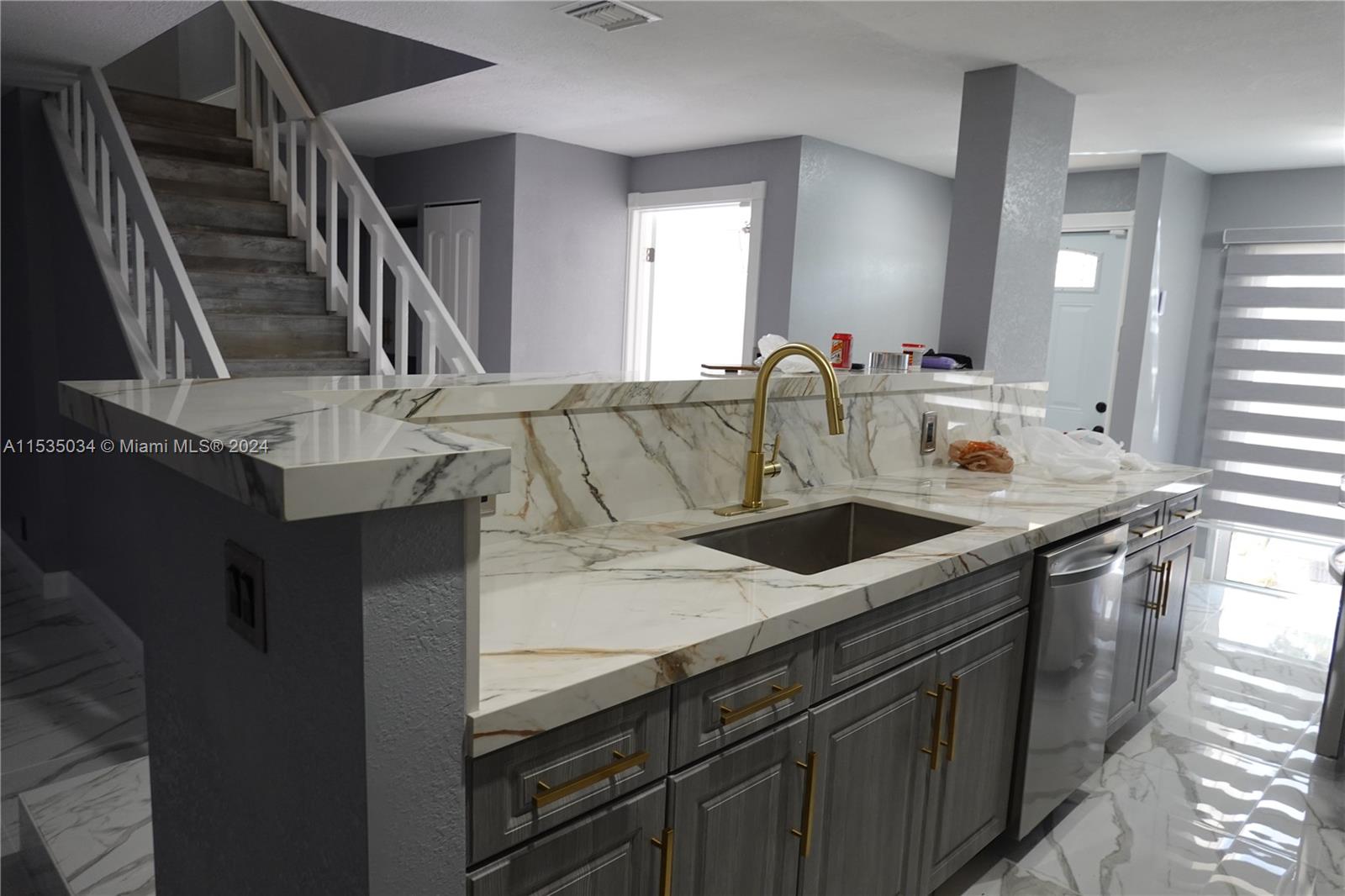 Townhouses at Jacaranda Condominiums Plantation, FL 33324 - Photo 15 of 50 a kitchen with stainless steel appliances granite countertop a sink stove and cabinets