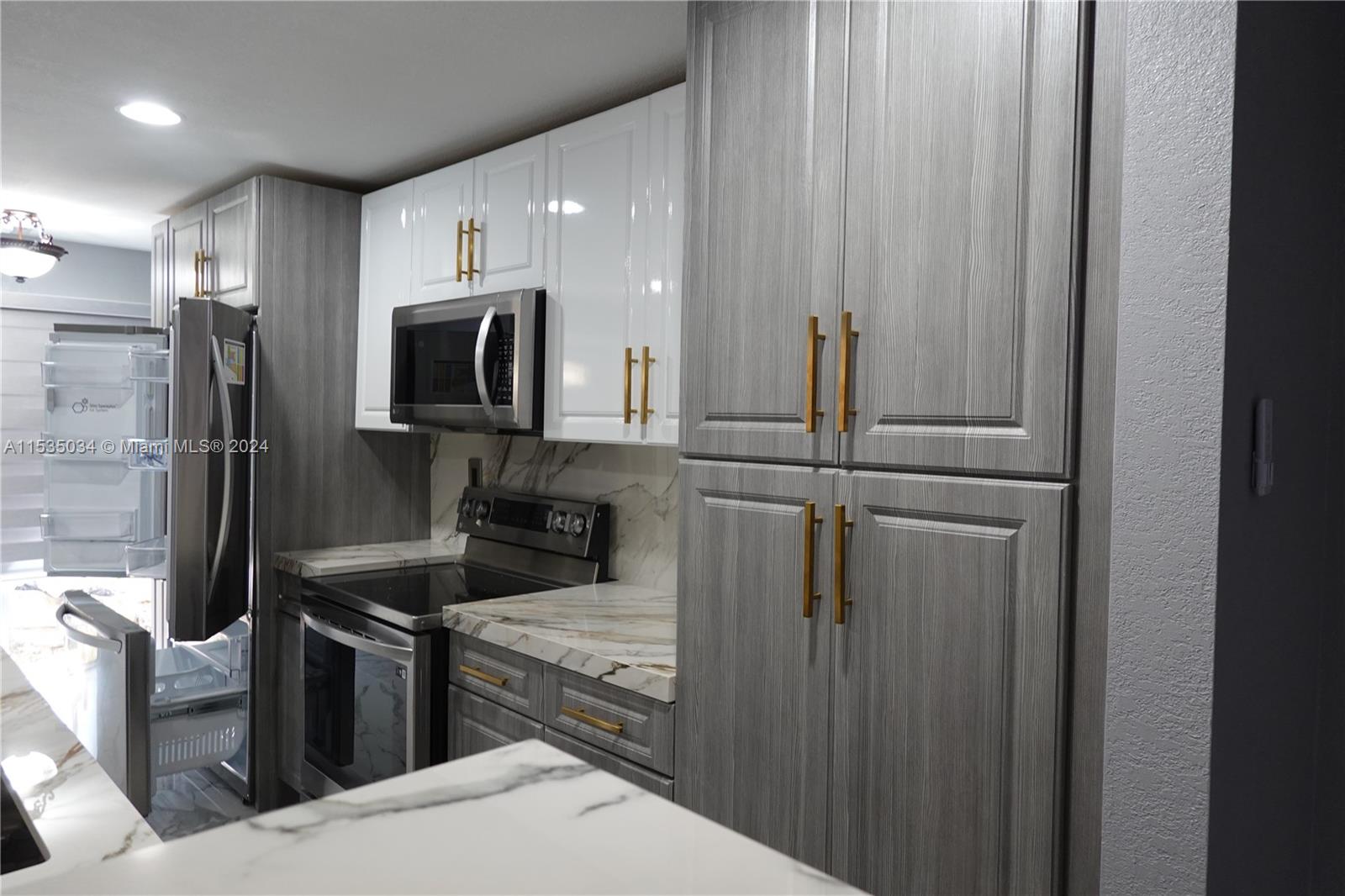 Townhouses at Jacaranda Condominiums Plantation, FL 33324 - Photo 16 of 50 a kitchen with a refrigerator and a sink