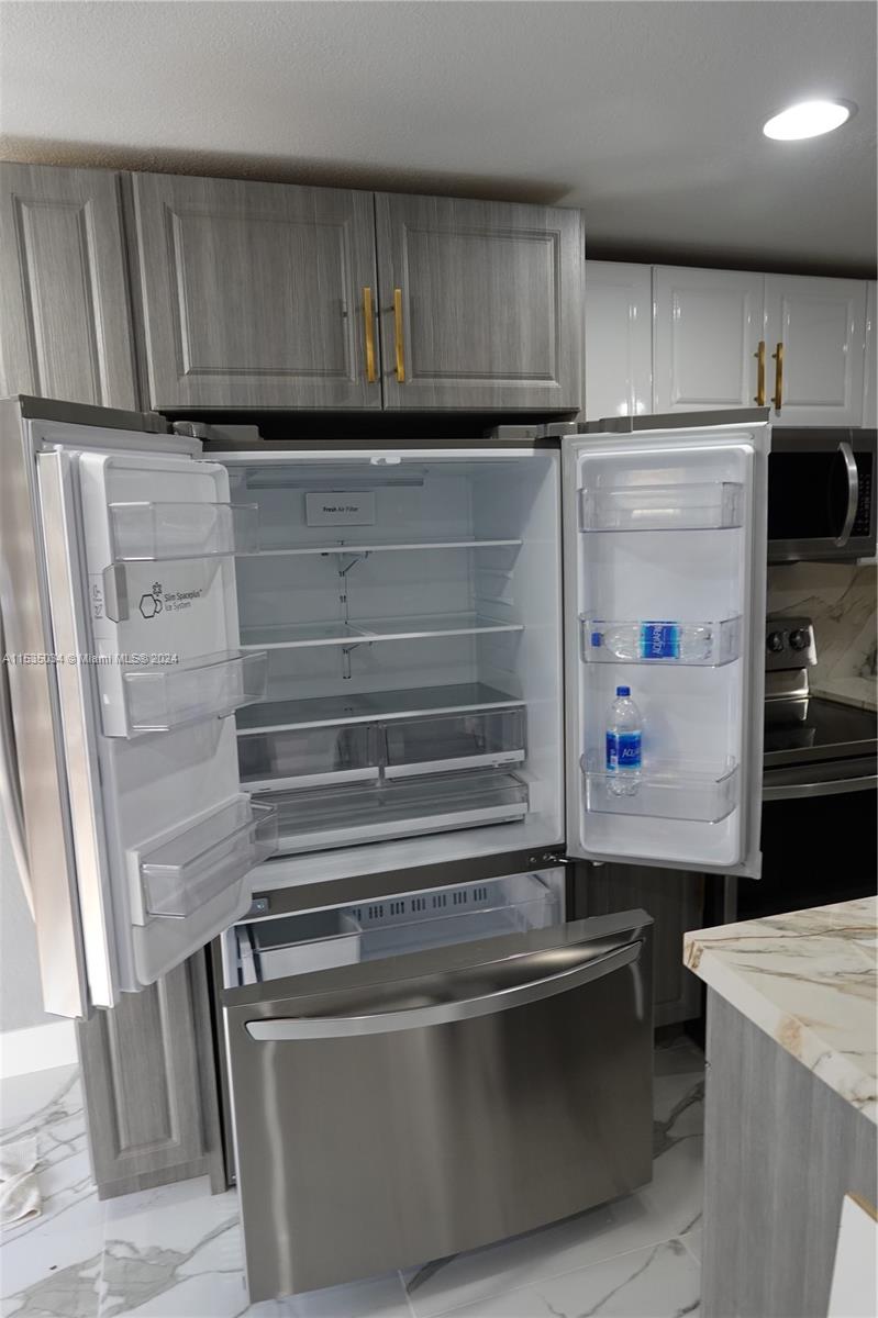 Townhouses at Jacaranda Condominiums Plantation, FL 33324 - Photo 17 of 50 a refrigerator freezer sitting inside of a kitchen