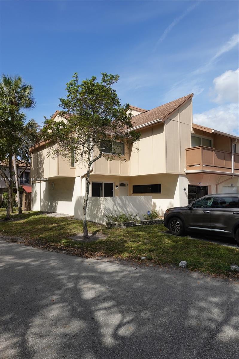 Townhouses at Jacaranda Condominiums Plantation, FL 33324 - Photo 2 of 50 a front view of a house with a yard