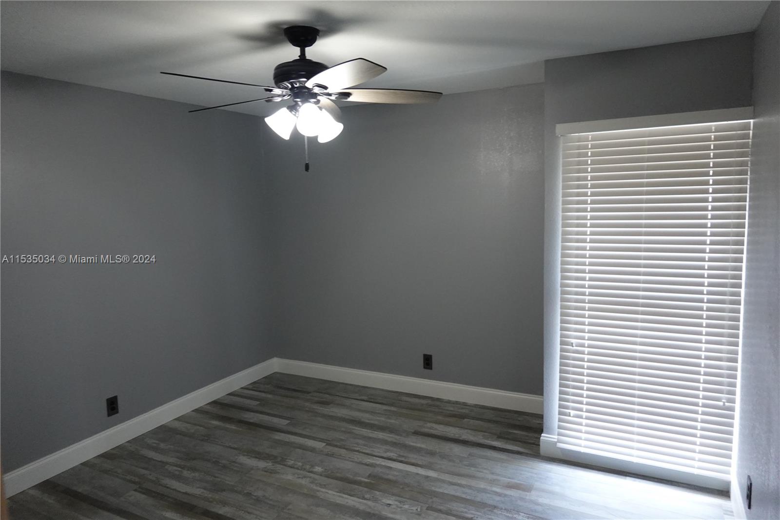Townhouses at Jacaranda Condominiums Plantation, FL 33324 - Photo 28 of 50 a view of a room with wooden floor and a fan