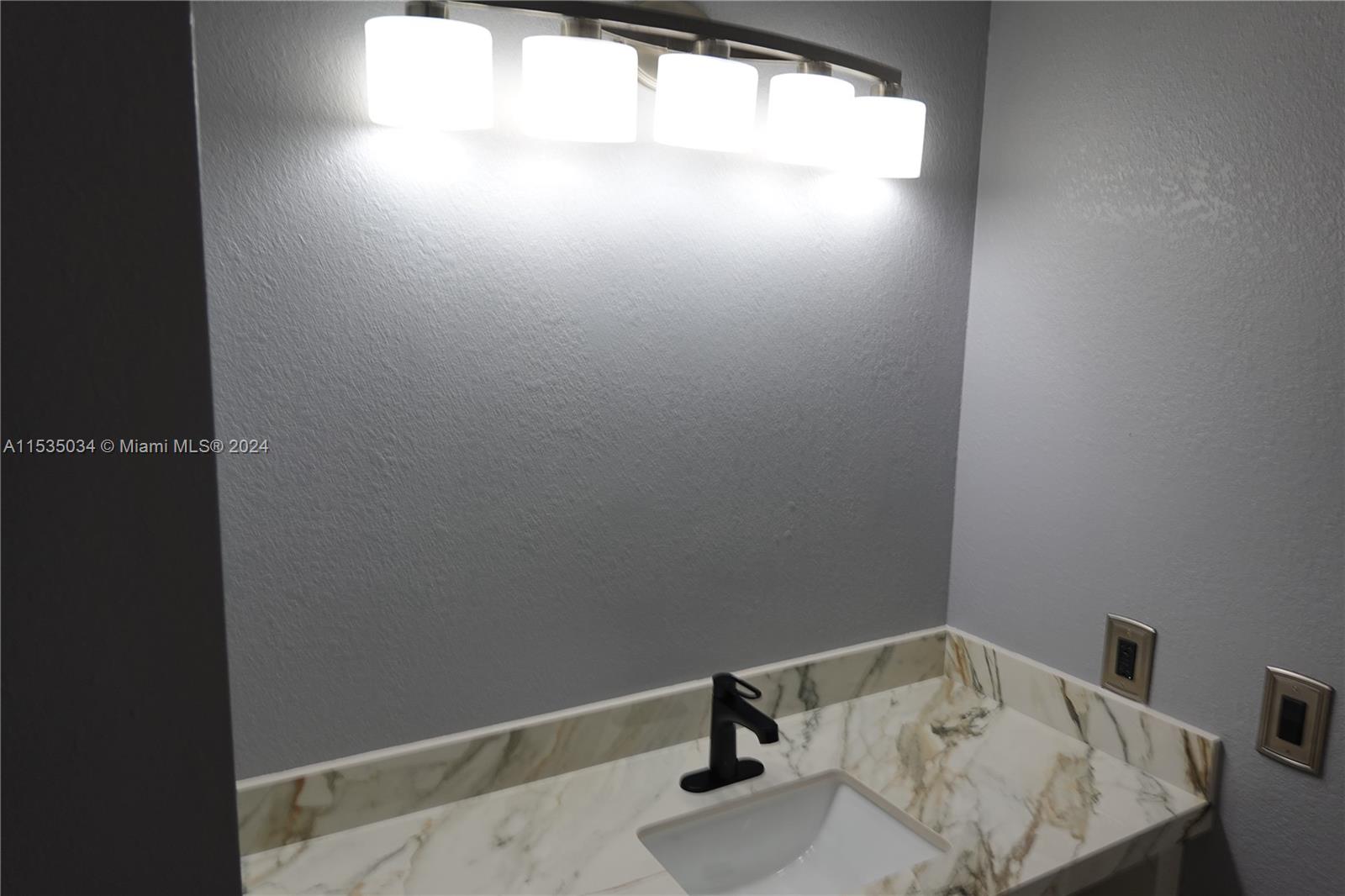 Townhouses at Jacaranda Condominiums Plantation, FL 33324 - Photo 32 of 50 a bathroom with a sink and a window