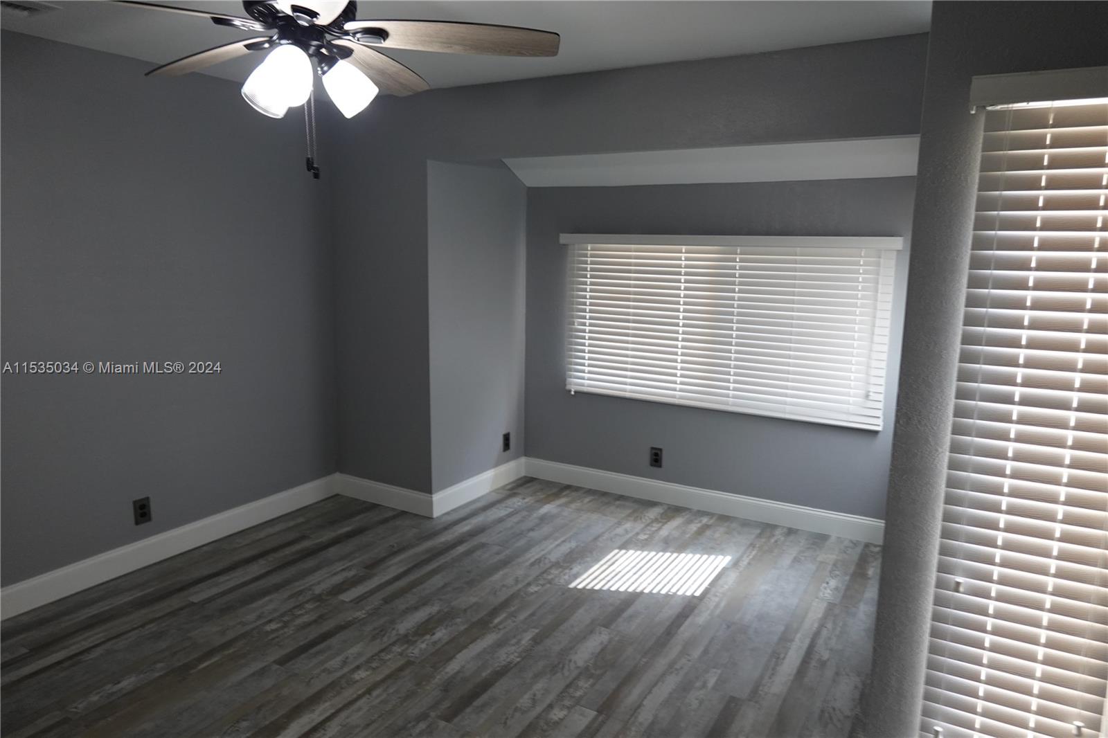 Townhouses at Jacaranda Condominiums Plantation, FL 33324 - Photo 40 of 50 a view of an empty room with wooden floor and a window