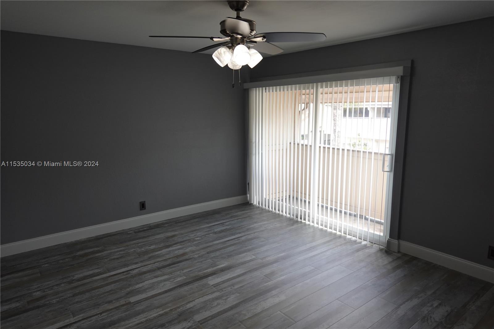 Townhouses at Jacaranda Condominiums Plantation, FL 33324 - Photo 43 of 50 a view of an empty room with wooden floor and a window