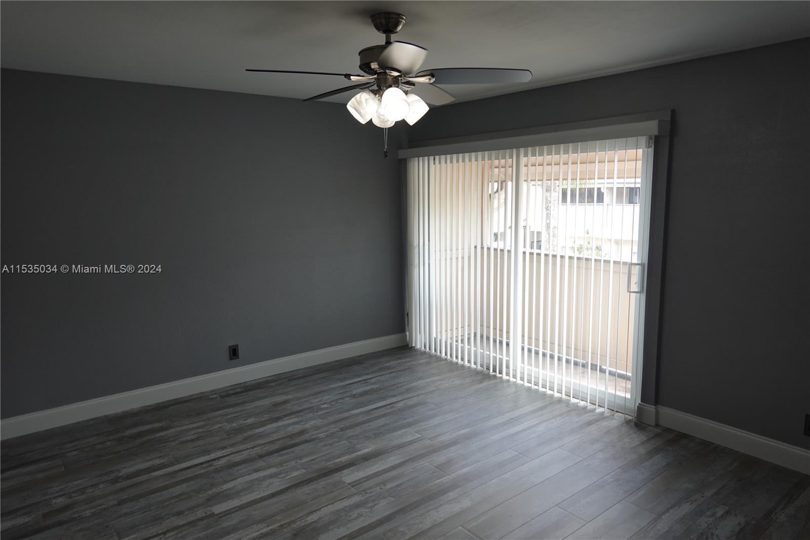Townhouses at Jacaranda Condominiums Plantation, FL 33324 - Photo 44 of 50 a view of an empty room with wooden floor and a window