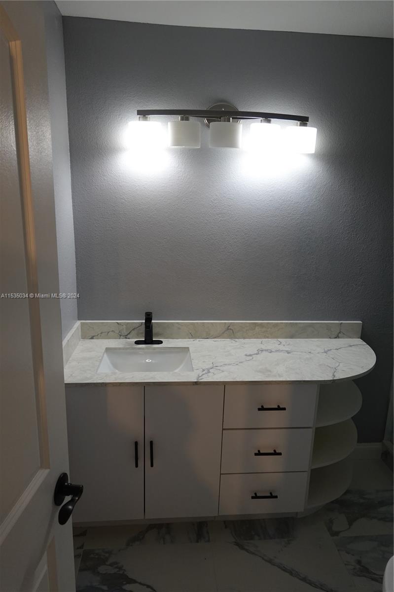 Townhouses at Jacaranda Condominiums Plantation, FL 33324 - Photo 49 of 50 a bathroom with a sink and vanity
