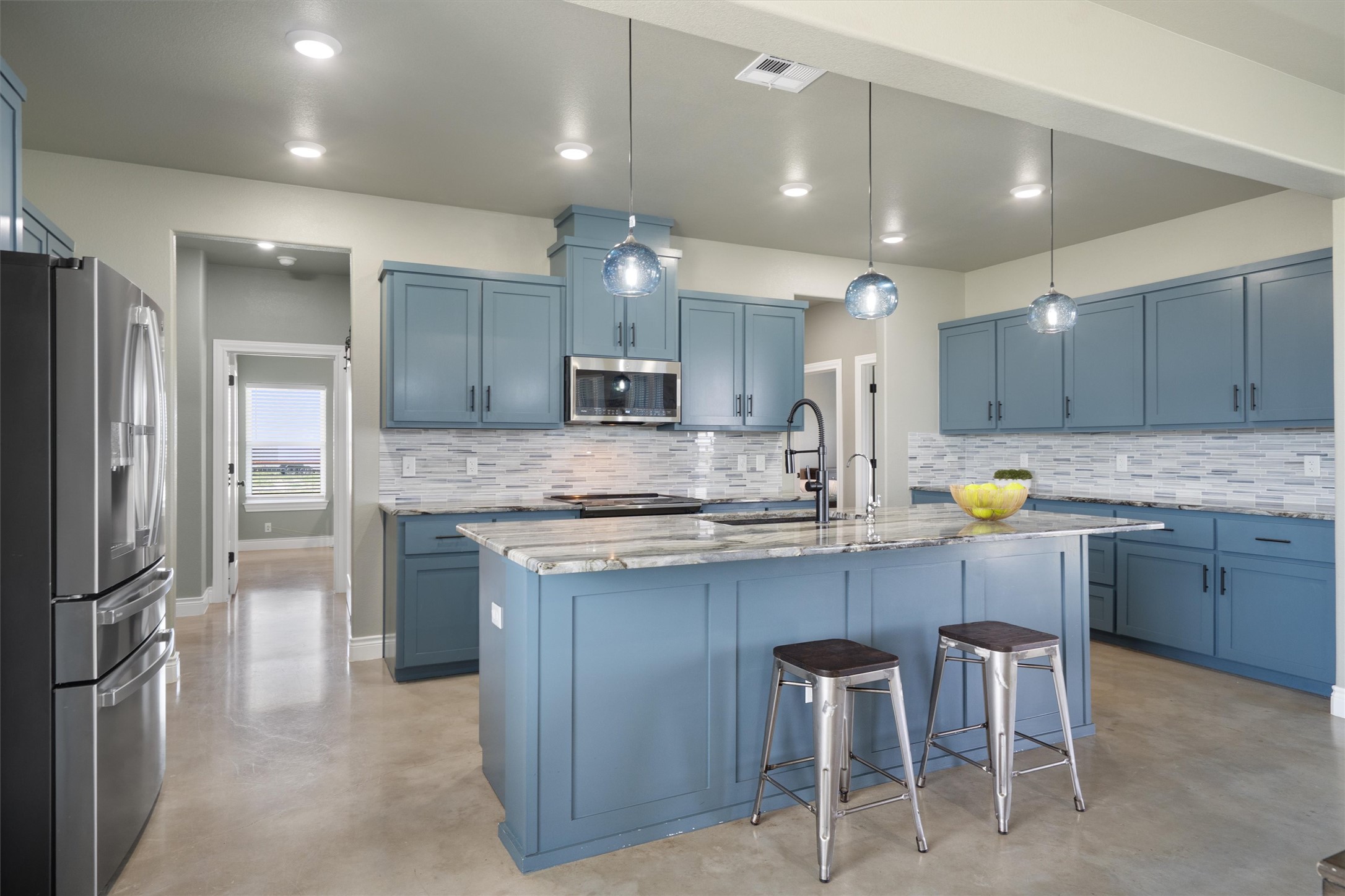 15073 Armstrong Estates Road Salado, TX 76571 - Photo 12 of 40 a kitchen with kitchen island granite countertop wooden cabinets and refrigerator