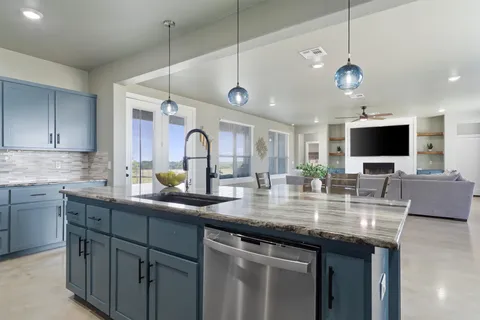 a kitchen with stainless steel appliances granite countertop a sink and a microwave
