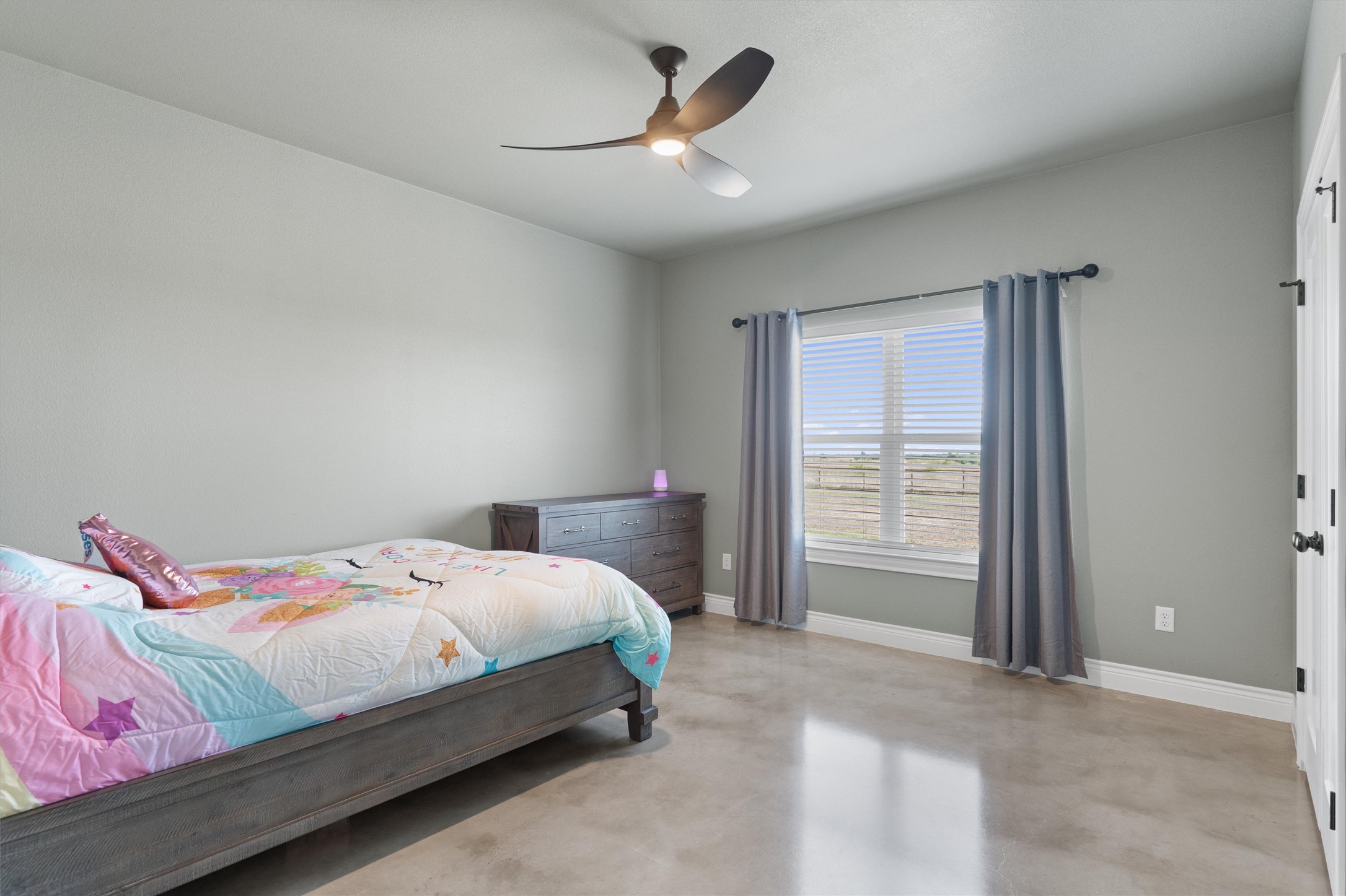 15073 Armstrong Estates Road Salado, TX 76571 - Photo 20 of 40 a bedroom with a bed and a chandelier